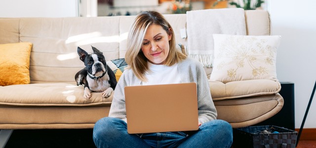 Kvinne studerer hjemme på PC